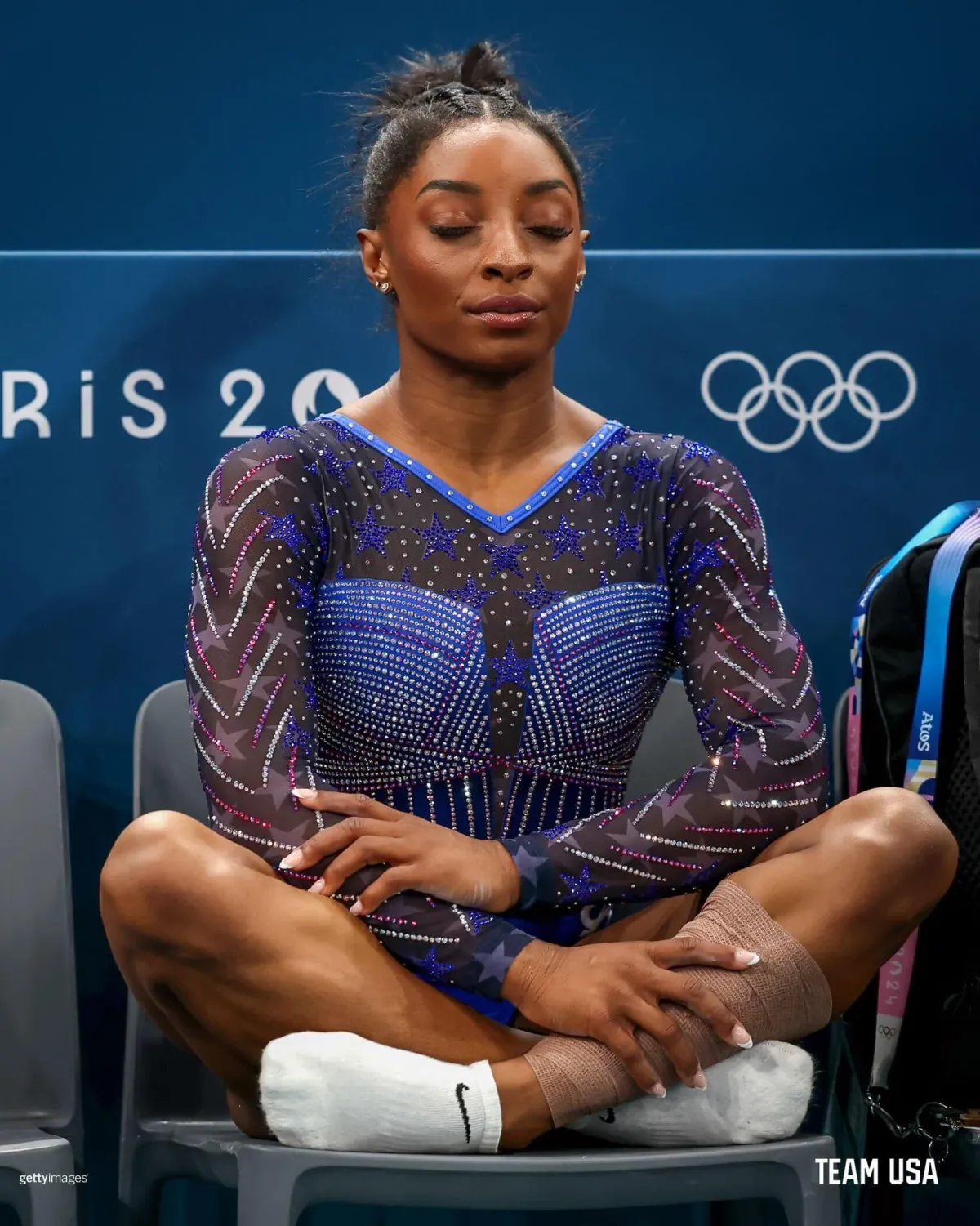 Simone Biles sitting with her eyes closed before competing.
